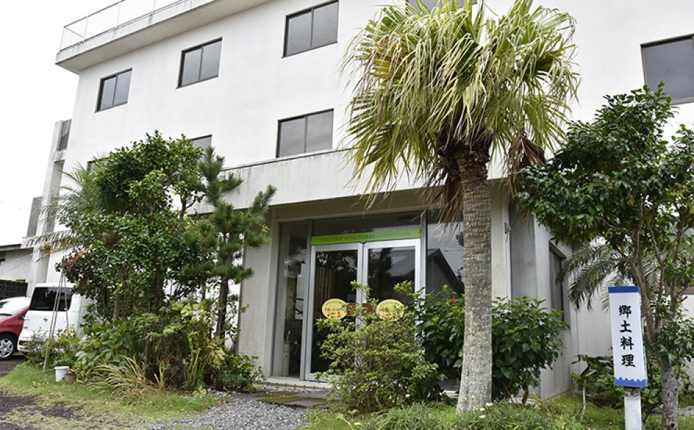 玄関脇のヤシの木が南国ムード満点