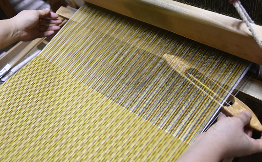 3色の糸から味わい深い反物が織られる